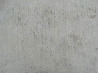 Gray concrete ground floor with black spots and thin lines