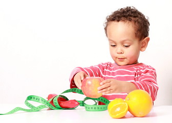 Fototapeta na wymiar little boy holding fresh fruits promoting healthy eating
