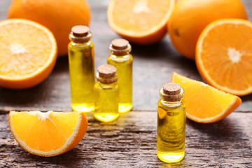Orange oil in bottles on grey wooden table