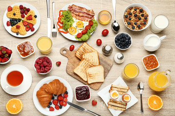 Tasty breakfast on wooden table