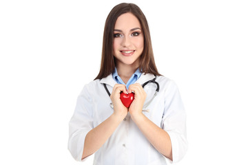 Portrait of young doctor with stethoscope and red heart on white background