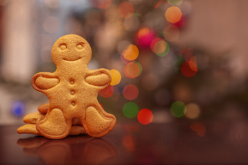 Christmas homemade gingerbread cookies on colorful bokeh background.