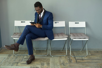 stylish man in a suit looks into a laptop in the office