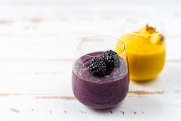 Colorful yellow and blue smoothie in two glasses
