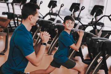 Young Father and Son Preparing for Training in Gym