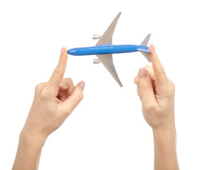 Miniature airplane in hand travel on white background isolation