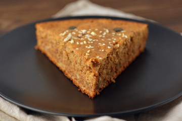 piece of pecan pie on a black plate at an angle of 45