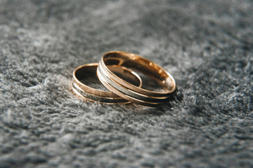 Wedding wedding rings on a gray background, selective focus, macro