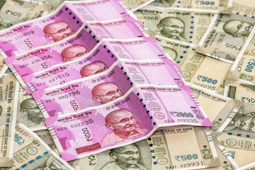 Close up view of brand new indian 2000 rupees banknotes. 500 rupee banknotes in background.