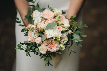 Bridal morning details. Wedding bouquet in the hands of the bride, selectoin focus