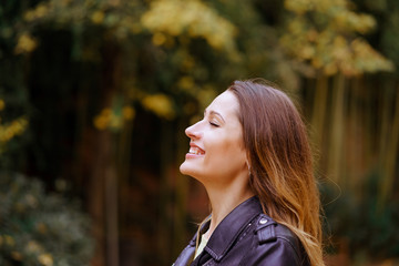 portrait of young happy woman breathing in the park