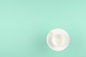 Empty cup on green background