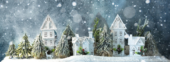 Frosty winter long banner wonderland forest with snowfall, houses and trees. Christmas greetings concept