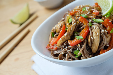 Dark pasta with steamed vegetables and grilled chicken. Delicious buckwheat noodles with vegetables and chicken