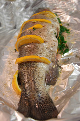 Trout fish filled by orange, herbs and spices and ready to cook