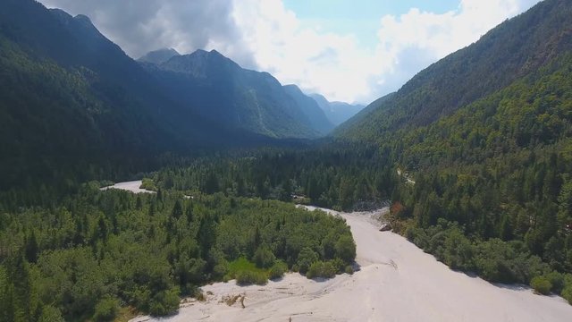 Aerial view of dry riverbed near Lake Predil and mountains in background near Tarvisio in European Alps, Italy