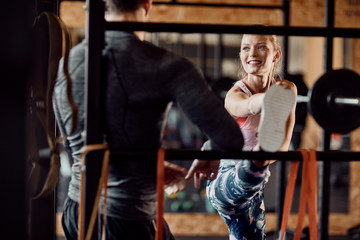 Fit model and her fitness instructor working out in an indoor fitness studio