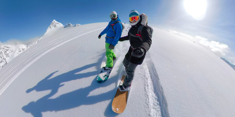 VR 360: Active young couple snowboarding together off piste on a sunny day. - obrazy, fototapety, plakaty