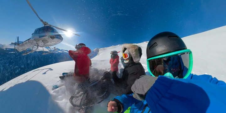 SELFIE: Group of extreme snowboarders waiting for the helicopter to pick them up