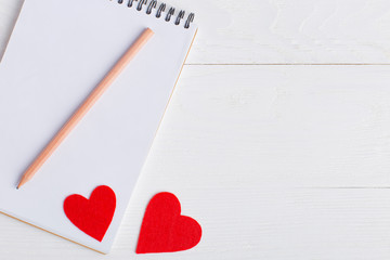 Notepad and red heart on a white background. Place for text, copy space.