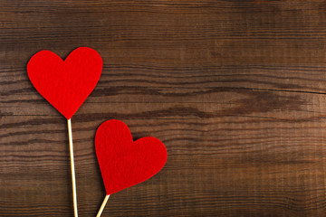 Red hearts on a wooden table. Blank or greeting card background for Valentine's Day. Place for text, copy space.