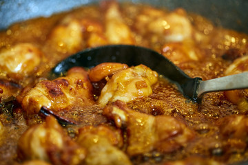 Chicken wings in a wok, boiling