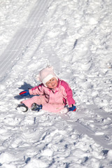 Fototapeta na wymiar little girl falling in snow