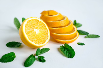 Orange with mint on a light background. Healthy food products. Vitamin C. Beautiful orange photo