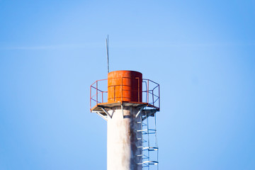 Pipe against blue sky, industry, environmental pollution