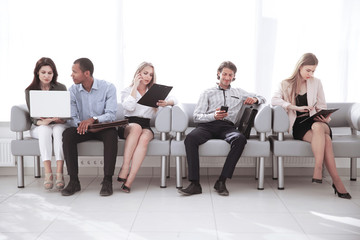 business team studying the working documents sitting in the lobby of the office.