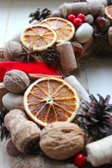 Christmas card. Background Christmas and new year. Christmas wreath of nuts, cones, dried oranges, corks of champagne, cinnamon sticks, ribbons. Christmas in a rustic style. Handmade decor. Christmas 
