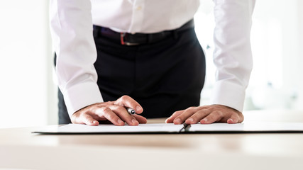 Business employer signing an application form