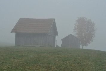 Old wooden abandoned shepherd's barn on green mountain hills pasture