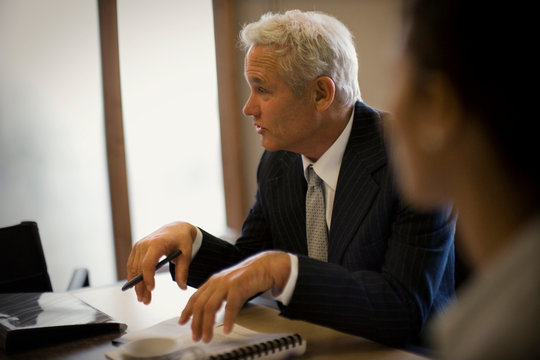Mature adult businessman sitting in an office.