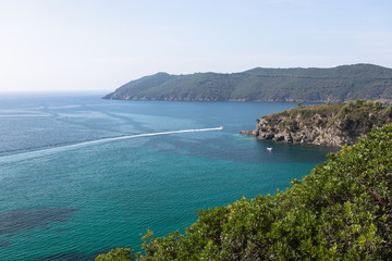 Beautiful sea view or the emerald sea of the island of Elba in Tuscany with a speedboat crossing the horizon. Elba island, Tuscany, Italy