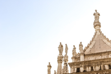 Fototapeta na wymiar Statues on the top of the north end of the Doge's palace: Arco Foscari building in Venice