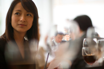 Young adult business woman sitting in restaurant.