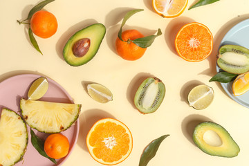 Citrus food on ligth-yellow background - assorted citrus fruits with mint leaves. Top view.