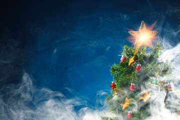 Christmas tree in ice fog, blue background