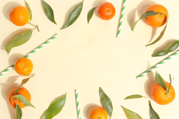Citrus food on ligth-yellow background - assorted citrus fruits with mint leaves. Top view.