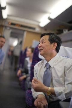 Mature businessman sitting on a train.