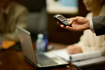 Cellphone being used in a boardroom.