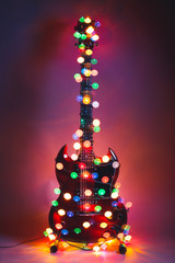 electric guitar with Christmas garland lights