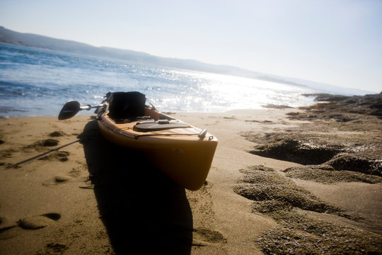 Kayak resting on a sandy beach.