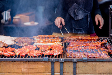 Traditional european grilled meat with smoke on Christmas fair