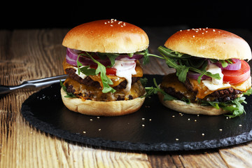 Tasty fresh meat burgers with salad and cheese. Homemade angus burger.