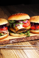 Tasty fresh meat burgers with salad and cheese. Homemade angus burger and Pulled pork sandwiches.