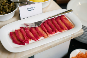 Marinated salmon and mackerel fish with sauces in bowl on kitche