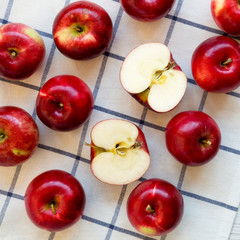 Fresh raw organic red apples on cloth, overhead view. Flat lay, from above, top view.