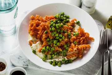 gluten-free healthy vegan red lentil pasta with green peas and cauliflower puree with garlic. tasty...